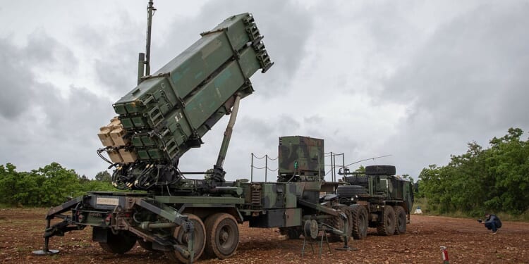 A Patriot missile system with its turret pointed upward.