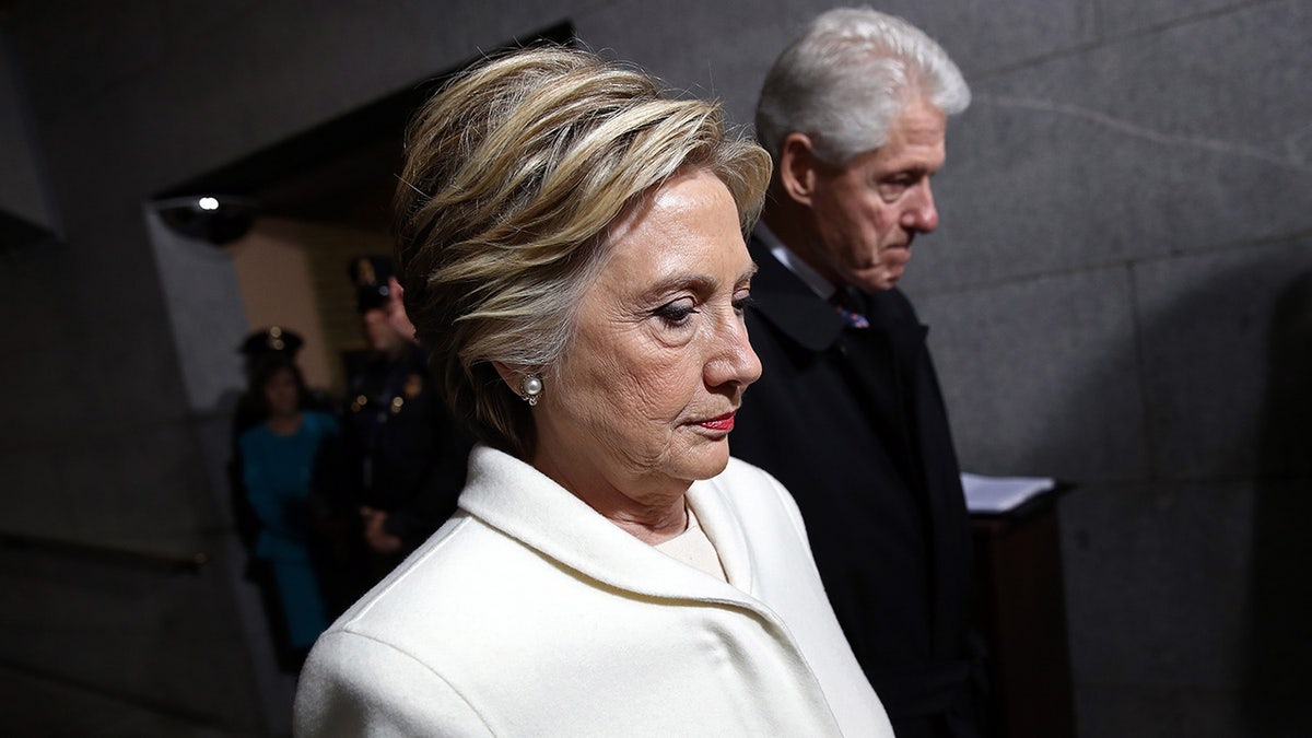 The Clintons walking through the Capitol.