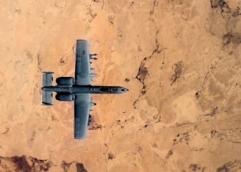 An A-10 Warthog flying over the desert.