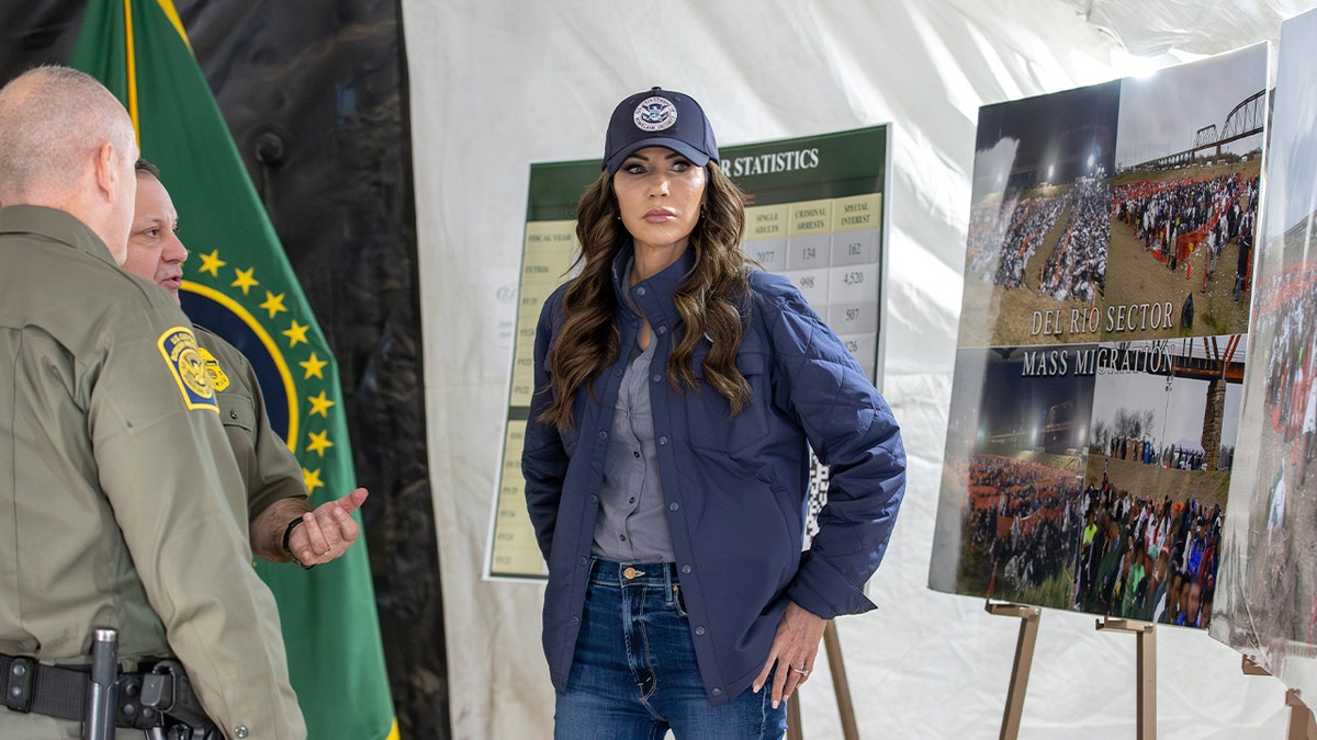 Kristi Noem standing with CBP officials outdoors in Eagle Pass, Texas