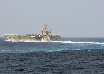 The USS Abraham Lincoln completes a turn in the ocean.