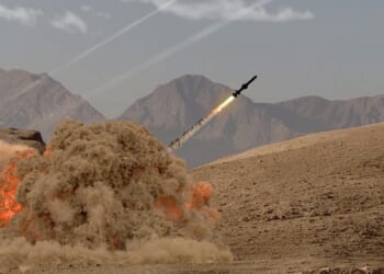 A missile being launched from the ground in the desert.