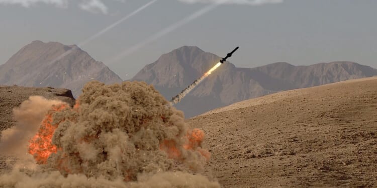 A missile being launched from the ground in the desert.