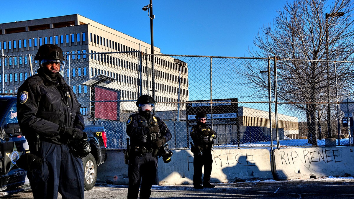 Federal immigration officers standing outside