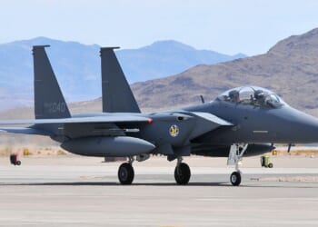 An F-15K "Slam Eagle" on the tarmac at an airfield.