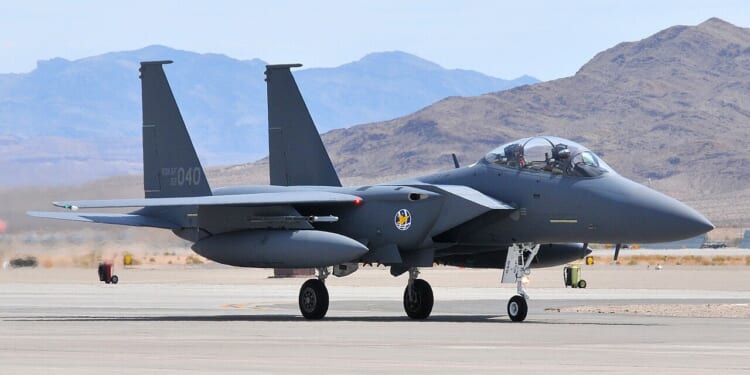 An F-15K "Slam Eagle" on the tarmac at an airfield.