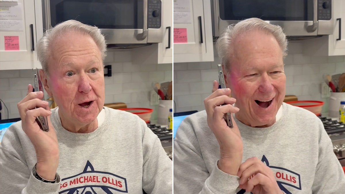 Family member reacts while speaking on the phone during a call confirming a Medal of Honor award.