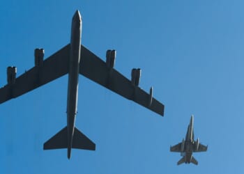 A B-52 Stratofortress and an F-16 Fighting Falcon flying next to each other.