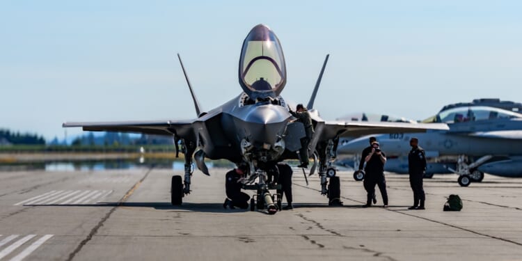 A group of mechanics working on an F-35.