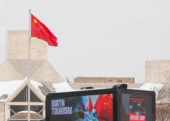 ‘The Invisible Coup’ Billboard Truck Takes Birth Tourism Bombshell to China’s Embassy Doorstep