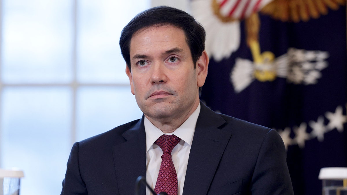 Secretary of State Marco Rubio stands attentively in the East Room during a meeting with energy industry leaders at the White House.