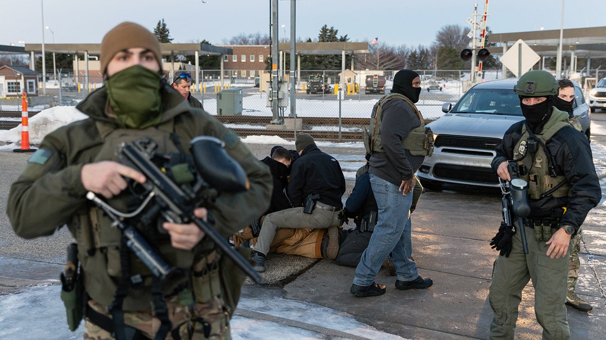 DHS agents arresting an individual