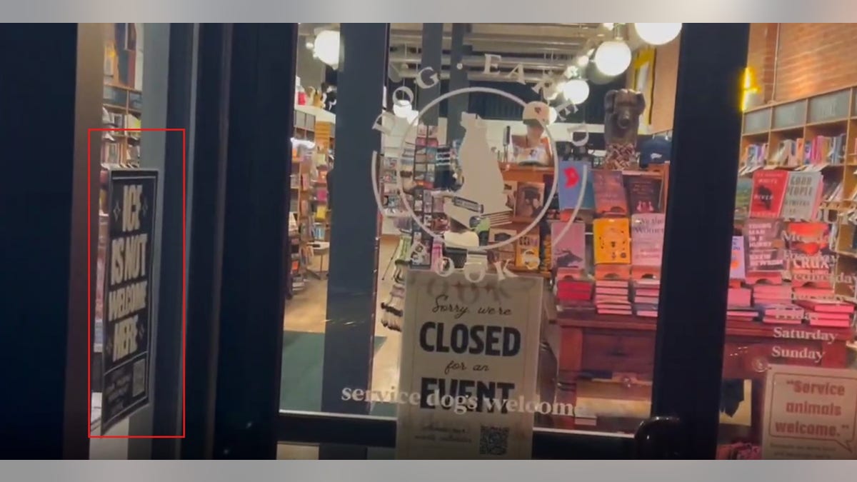 Image of Dog-Eared Books during campaign event for Zach Wahls shows anti-ICE poster in window