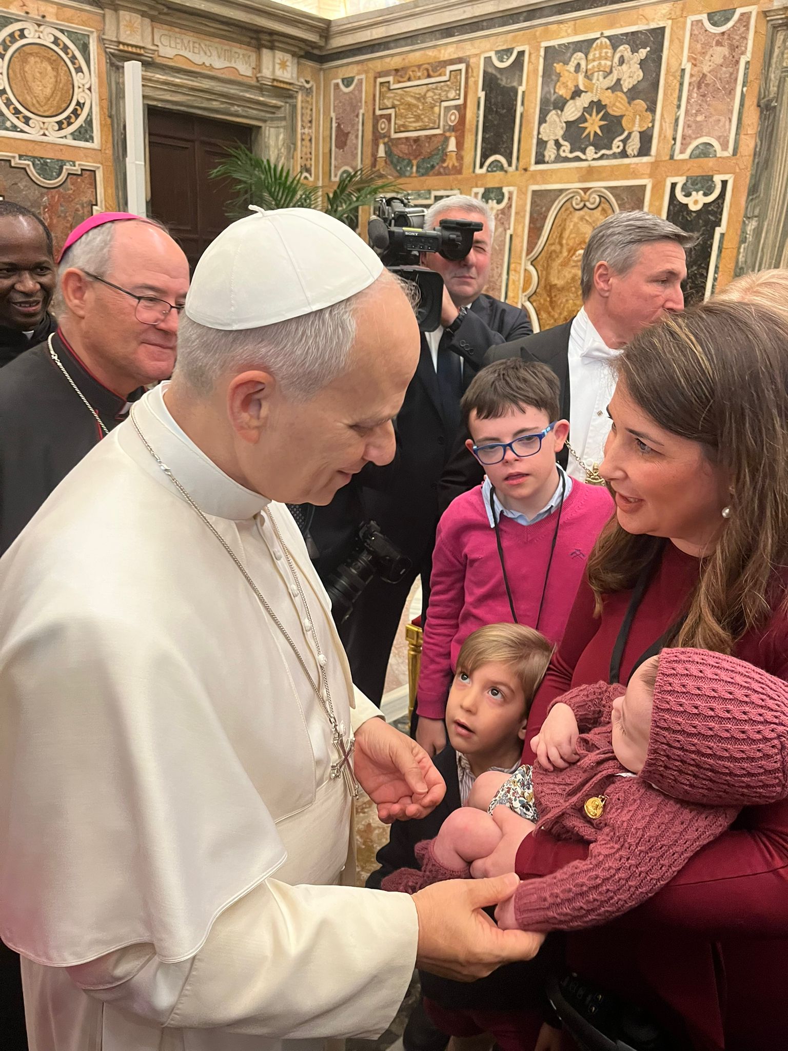 Pope Leo XIV holds the youngest of the seven siblings in the Bejarano Calvo family, León. | Credit: Photo courtesy of the Bejarano Calvo family
