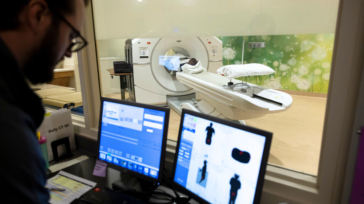 A researcher runs a scan on a patient at UCHealth University of Colorado Hospital in Aurora, CO, December 5, 2024.