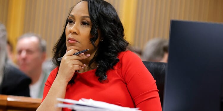 Judge bars Fani Willis from Trump legal fee fight after disqualification