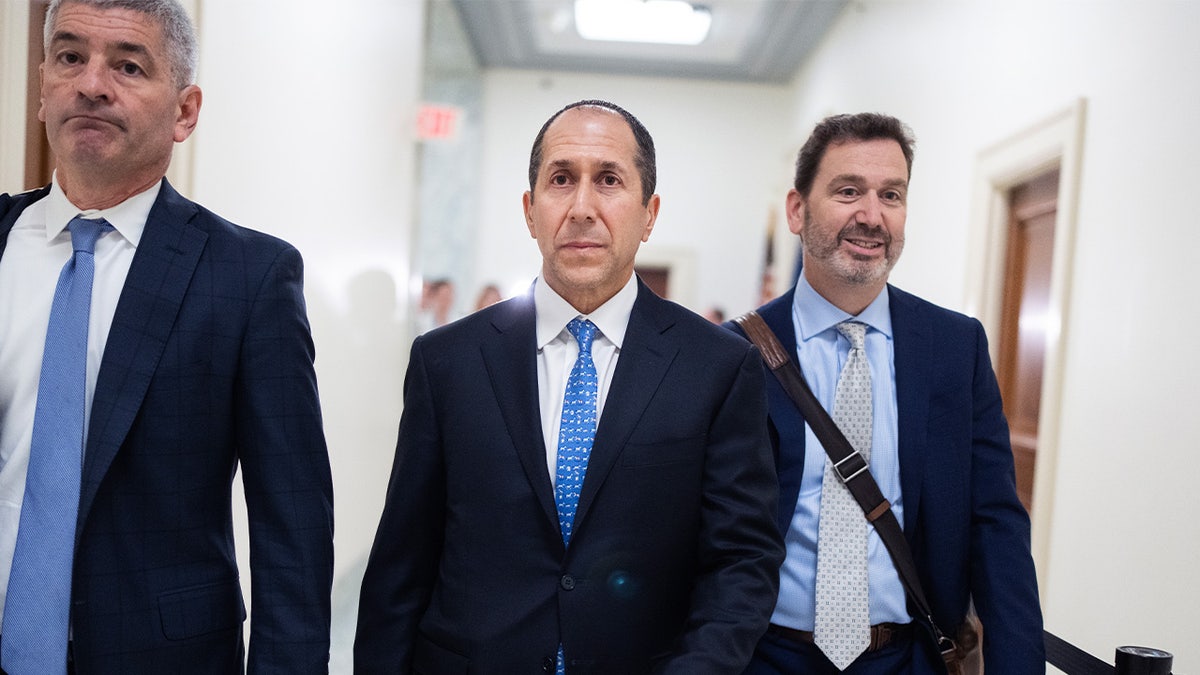Former Epstein accountant Richard Kahn walks to his House Oversight Committee deposition flanked by attorneys