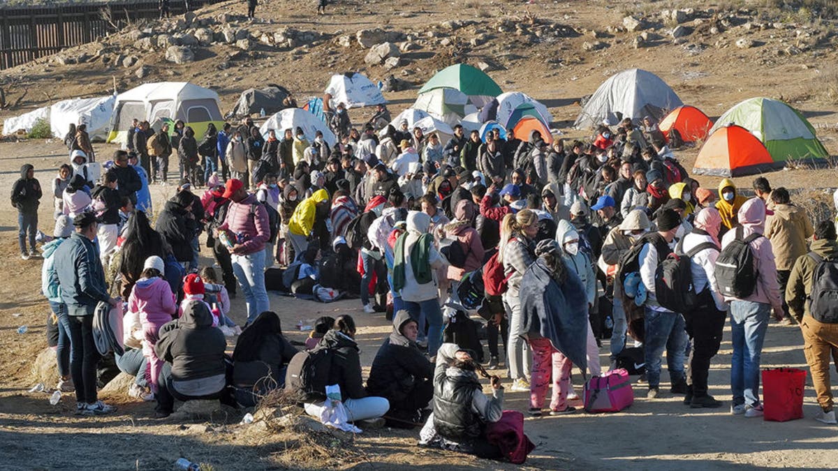 Migrants attempt to cross into the U.S. from Mexico at the border on Dec. 17, 2023, in Jacumba Hot Springs, California. (Getty Images)