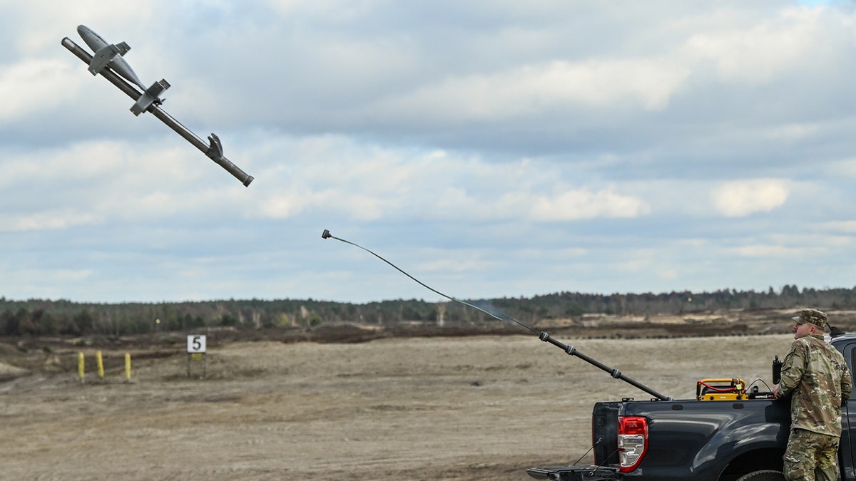 A Polish soldier is seen as he operates an interception drone of the American MEROPS counter drone system during tests at the Nowa Deba military training ground, south-eastern Poland, on November 18, 2025. 