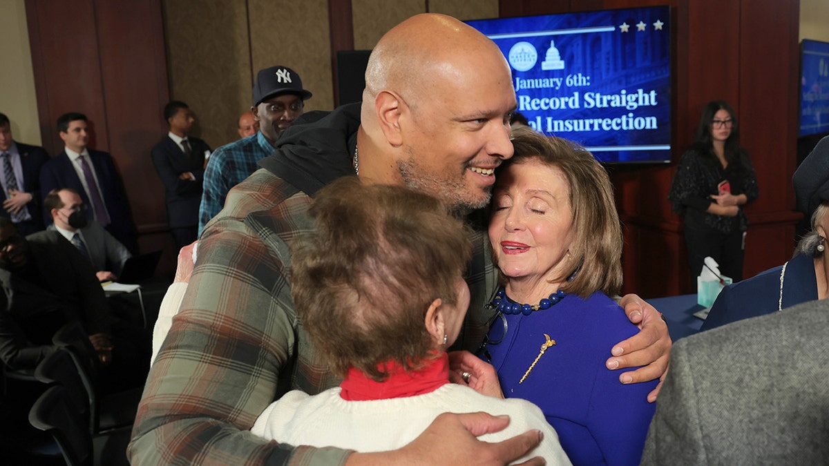 Harry Dunn hugs Nancy Pelosi and Gladys Sicknick