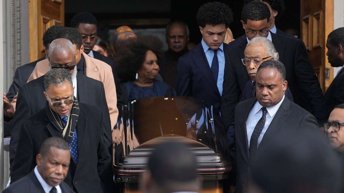 Members of the Jackson family walk with the casket after a memorial service.