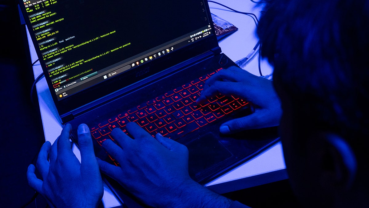 Hackers typing on a laptop.