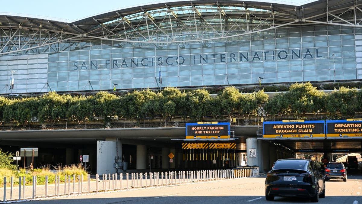 Exterior of San Francisco International Airport terminal with vehicles passing underneath
