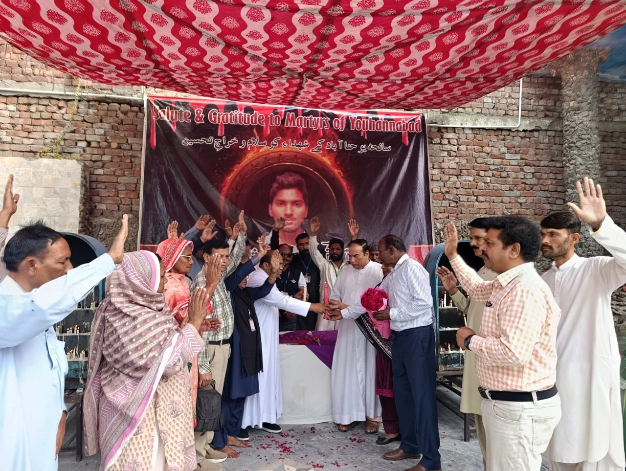 Father Akram Javed (fifth from right), parish priest of St. John’s Catholic Church, lights a memorial candle for Servant of God Akash Bashir at a commemoration in Youhanabad, Lahore, Pakistan, on March 15, 2025. | Credit: Kamran Chaudhry