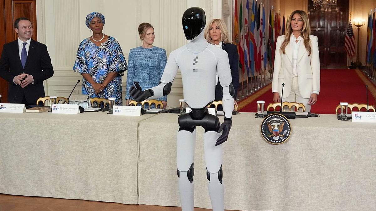 A humanoid robot next to Melania Trump