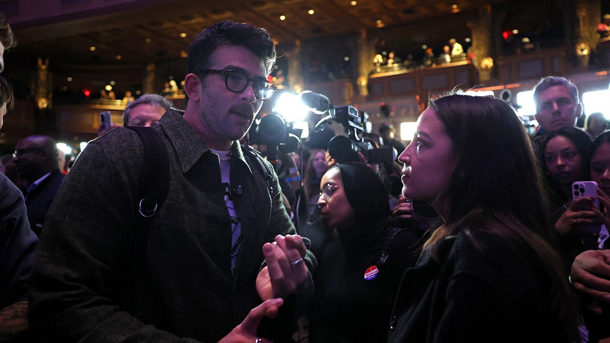 US Representative Alexandria Ocasio-Cortez (R) chats with supporters of New York City Mayoral candidate Zohran Mamdani