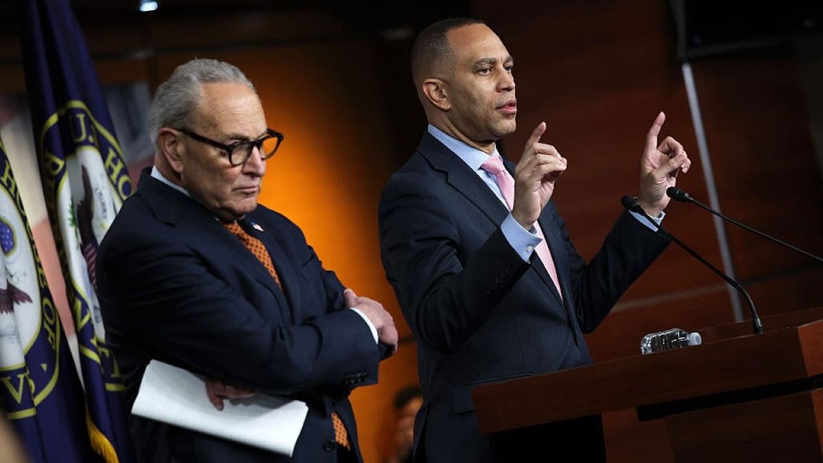 Hakeem Jeffries and Chuck Schumer speak at a press conference.