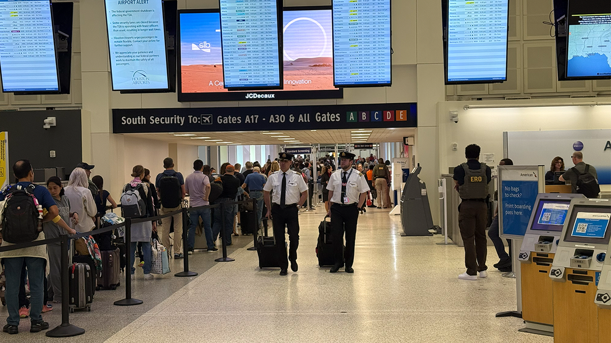 Pilots walk past ICE at airport