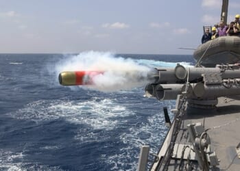 A US Navy ship firing a torpedo.