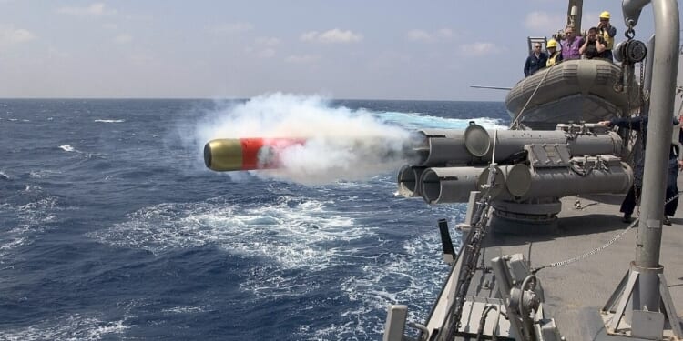 A US Navy ship firing a torpedo.