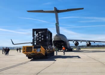 A small nuclear reactor being loaded onto a C-17 cargo plane.