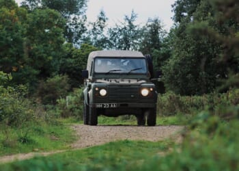 A British Army Land Rover on a dirt road.
