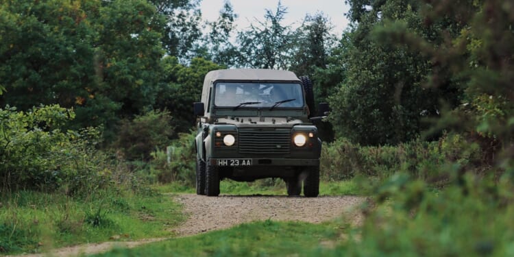 A British Army Land Rover on a dirt road.