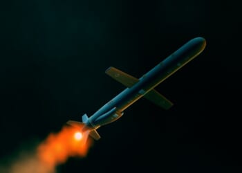 A Tomahawk missile in flight at night.