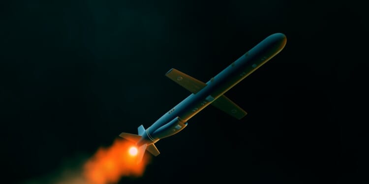 A Tomahawk missile in flight at night.