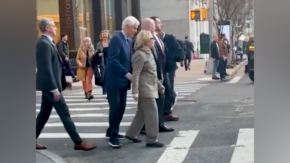 Video showed former Secretary of State and First Lady Hillary Clinton being nudged by her husband while attempting to cross a busy New York City Street.