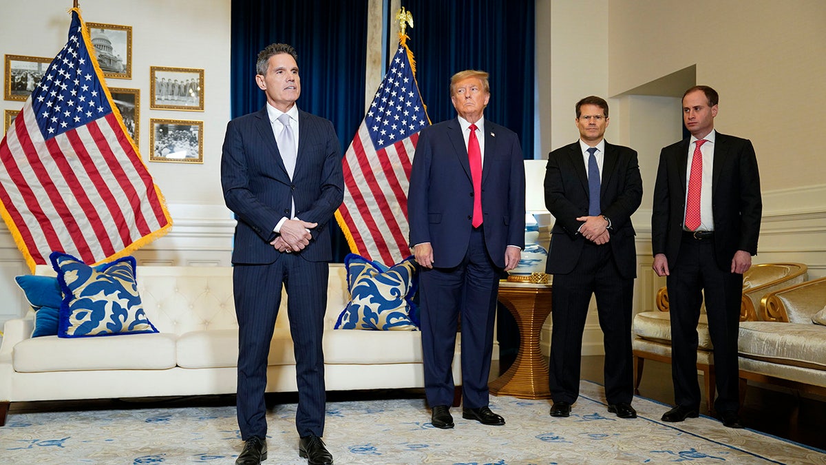 Donald Trump stands with lawyers John Laura, John Sauer and Will Scharf