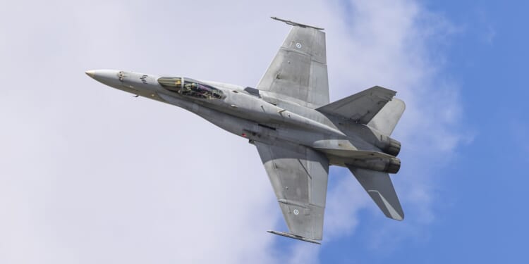 A Finnish F-18 fighter jet flying during an airshow.