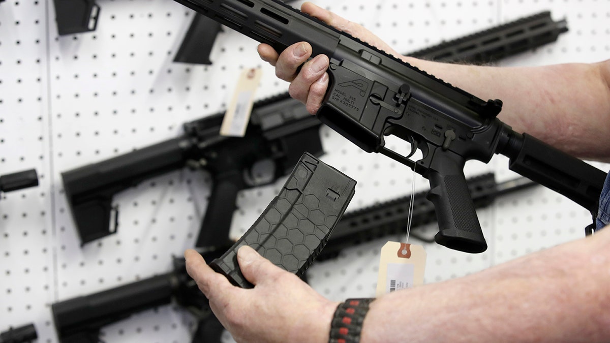 Person holds AR-15 rifle magazine