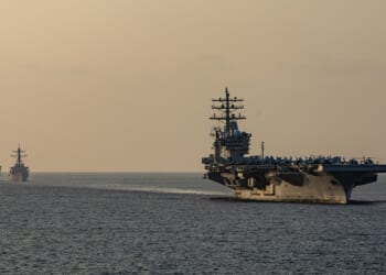 The USS Dwight D. Eisenhower and its carrier strike group sailing through the Strait of Hormuz.