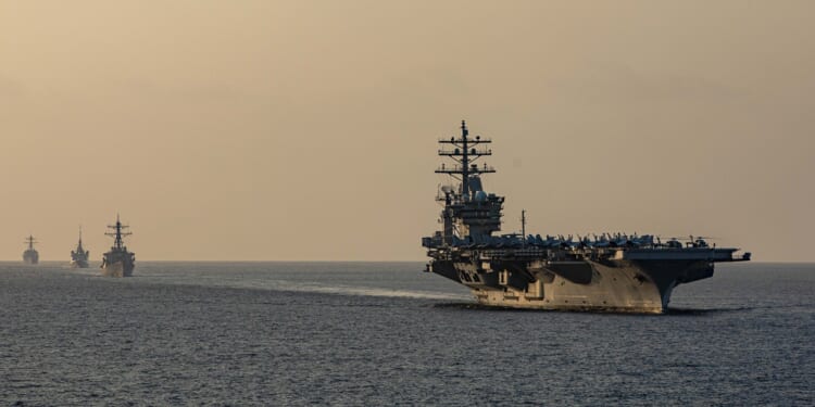 The USS Dwight D. Eisenhower and its carrier strike group sailing through the Strait of Hormuz.
