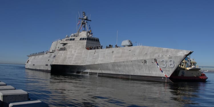 A Littoral Combat Ship at sea near a port.