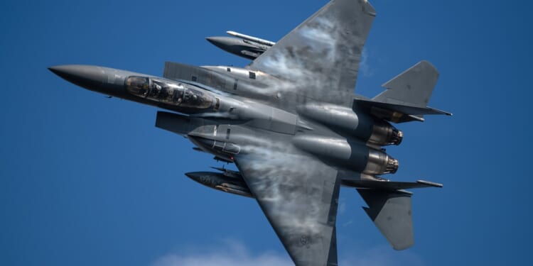 An F-15E Strike Eagle fighter jet in flight.