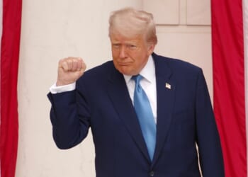 Trump pumps his fist during a Memorial Day ceremony.