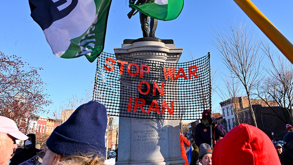 A sign reads "stop war on iran" during a protest in Albany, NY.