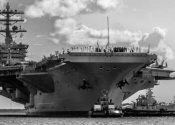 A black-and-white photo of the USS Nimitz aircraft carrier.
